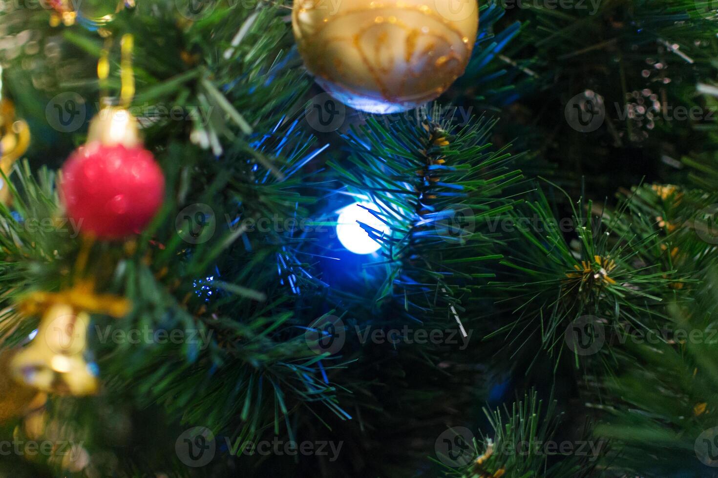Close-up of Christmas tree ornaments and lights. A festive, blurry image perfect for holiday backgrounds. photo