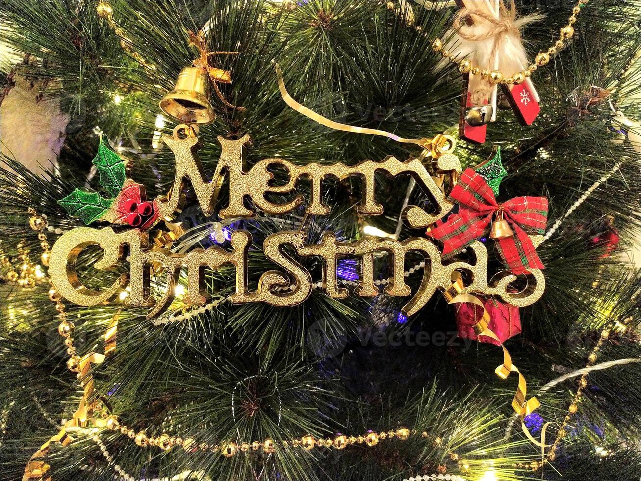 Close-up of a richly decorated Christmas tree, adorned with shimmering gold and pearl bead garlands, twinkling lights, and charming ornaments. photo
