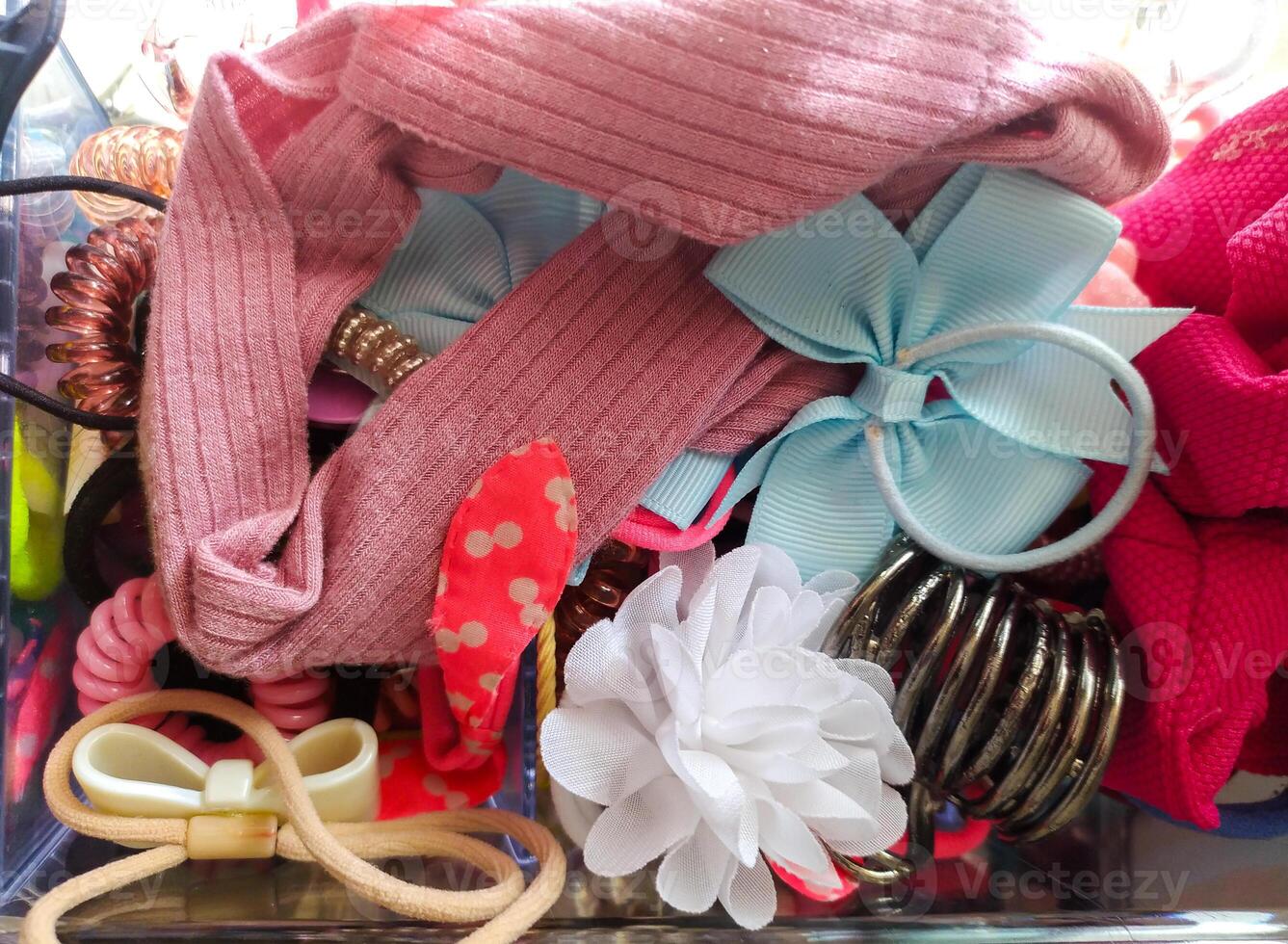 Overflowing container of colorful hair accessories. Concept childhood, organization, fashion. Use blog, webpage, print, social media posts. photo