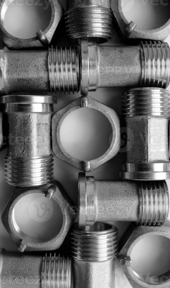 Sanitary And Water Plumbing Products. Cast Iron Fitting And Nuts For Piping Connection Texture Background photo