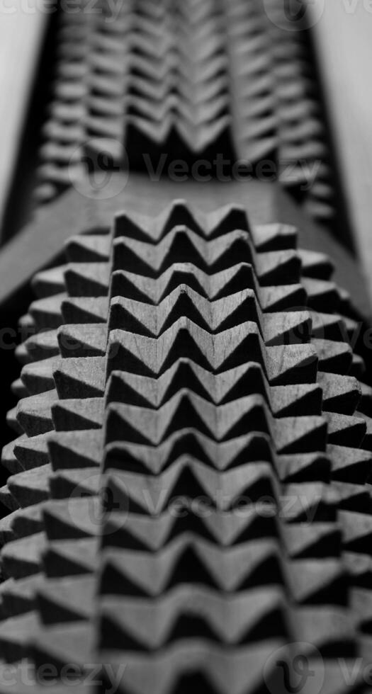 Identically spikes on jagged gray mechanism stock photo for vertical background