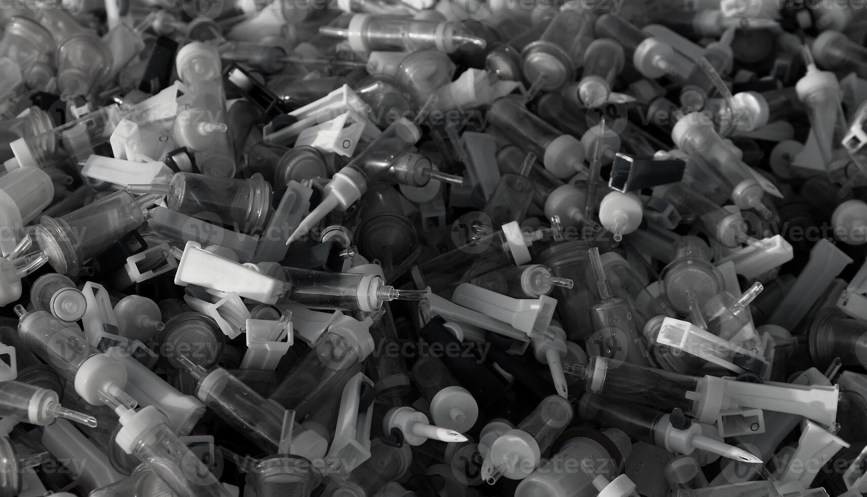 Used Plastic Blood Transfusion Droppers Waiting Safety Recycling Grayscale Image. Disposal Used Medical Tubes And Droppers Monochrome Background photo