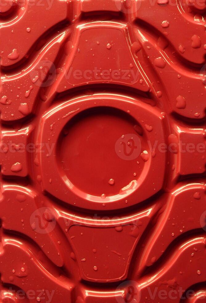 Water drops on a rad patterned plastic surface. Sock photo for abstract plastic backgrounds