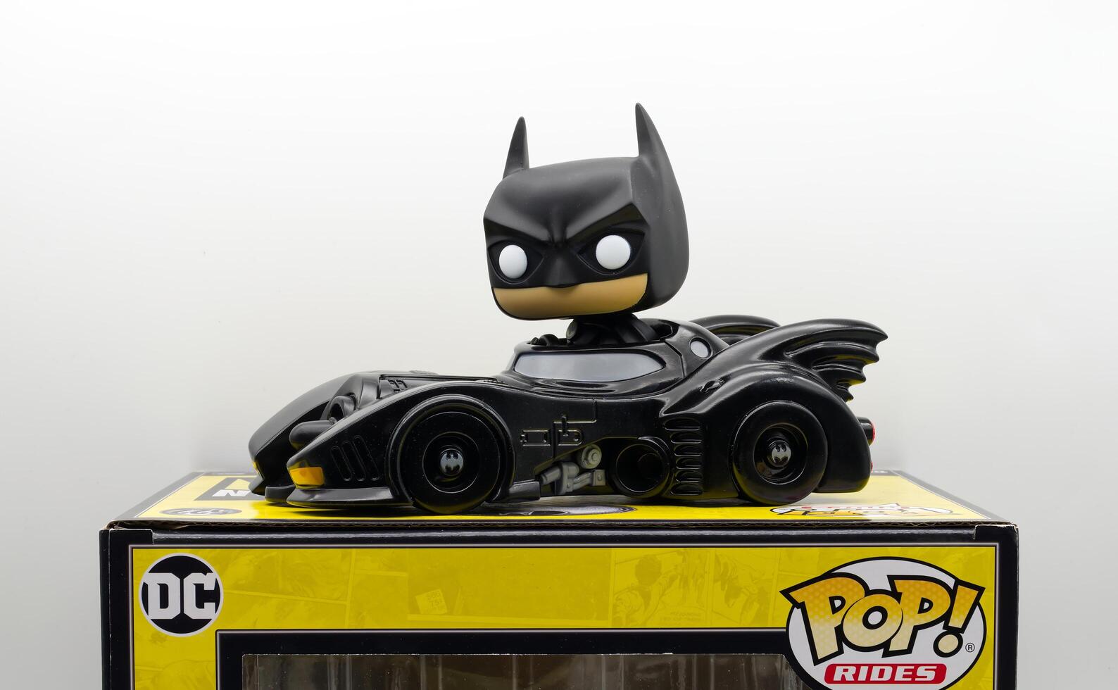 Bologna Italy April 8, 2025 Batman in Batmobile vinyl figure with box by Funko Pop Rides photo