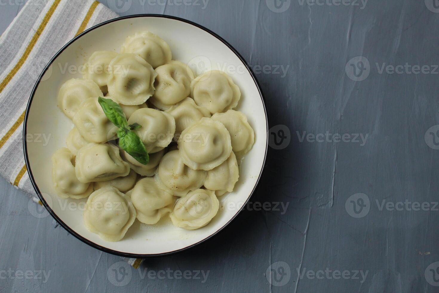 dumplings on a plate on a gray background with space for text copyspace top view upper angle. National food photo
