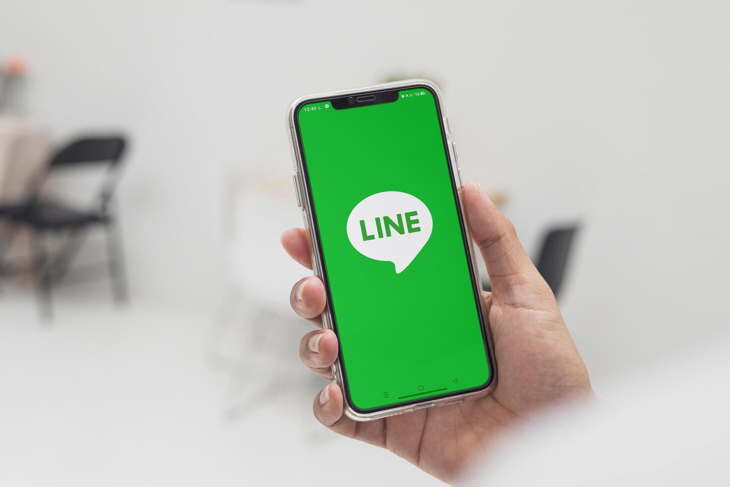 Bangkok, Thailand-15 April 2025 Popular LINE logo on smartphone, Businessman opening the LINE application on device for convenient, and fast communication and delivery of document file. photo