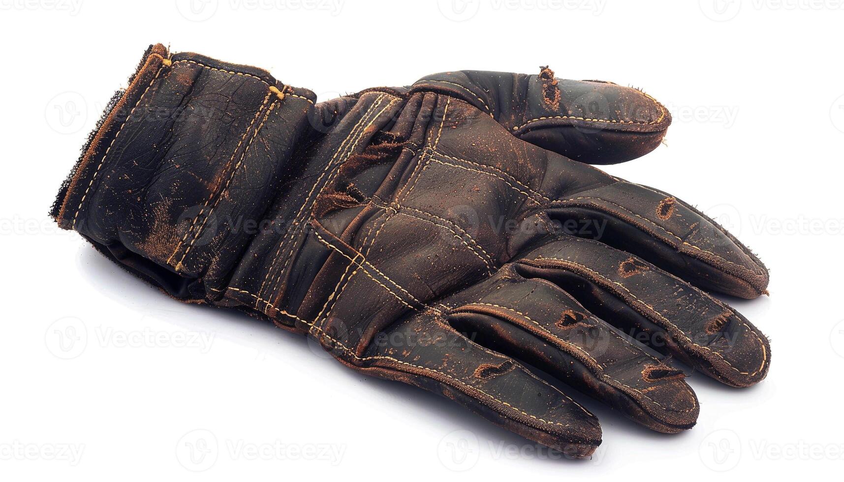 A weathered leather glove lies worn and torn, holding silent stories of labor, grit, and time. photo