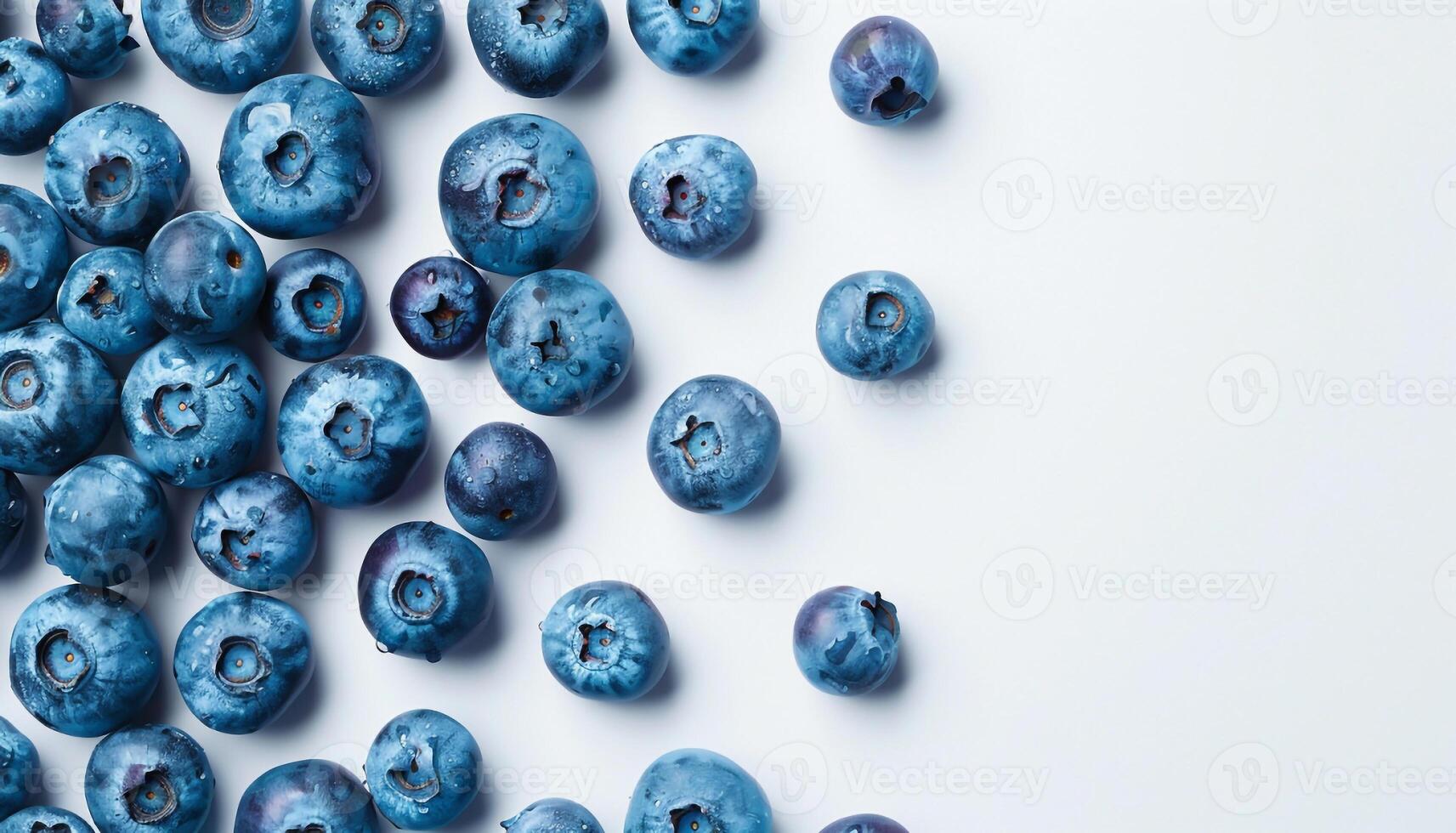 Fresh blueberries scattered on clean white background with empty space for text or branding top view photo