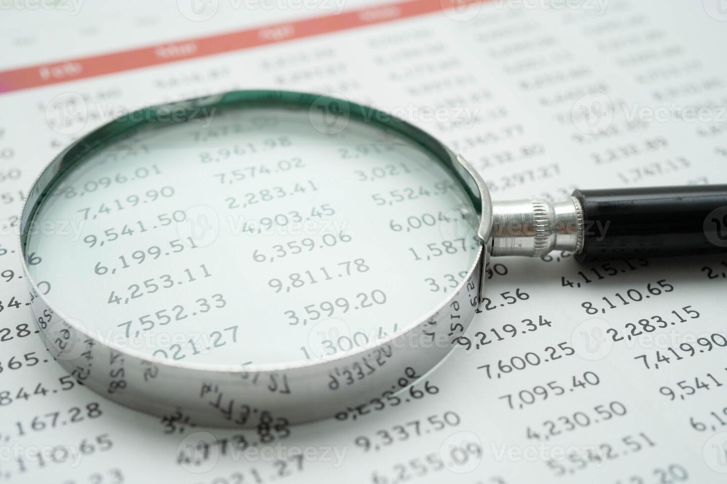 Magnifying glass on charts graphs paper. Financial development, Banking Account, Statistics, Investment Analytic r photo
