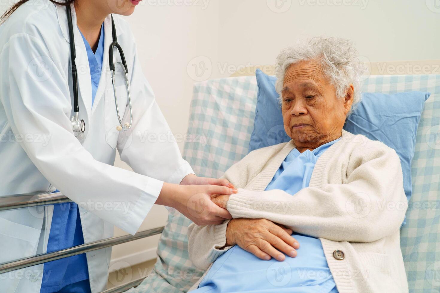 Asian doctor checking and treat elderly woman patient health in hosp photo