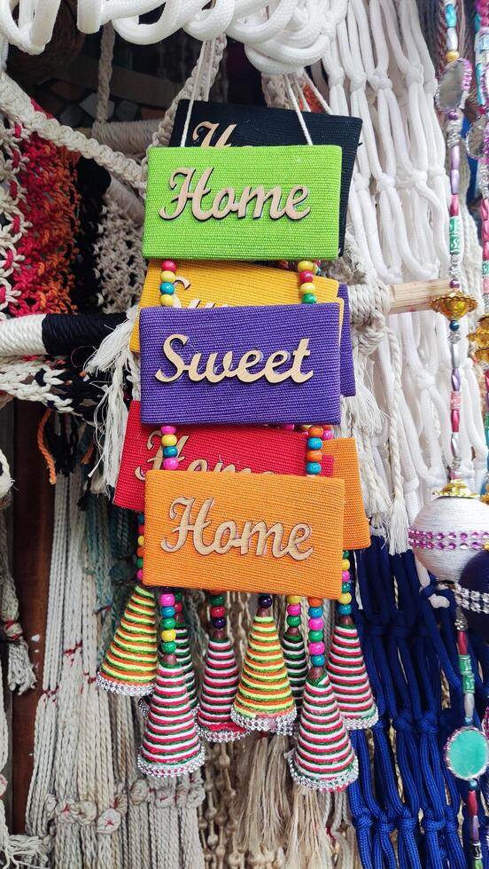 A display of colorful bells hanging from a string photo