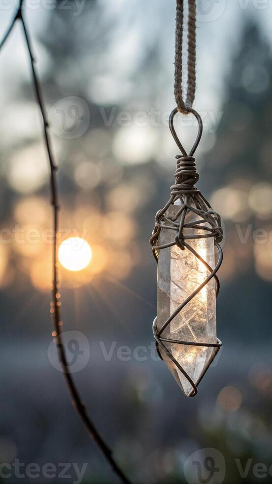 Clear Quarts Crystal Wire Wrapped on a Bokeh Blurry Background photo