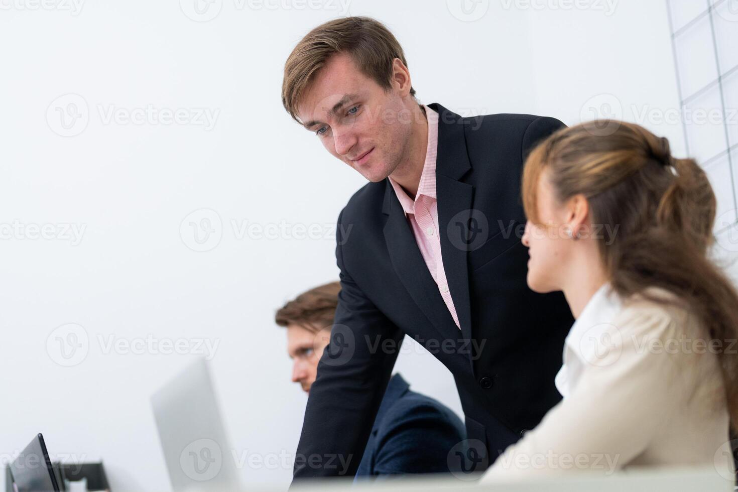 Business meeting in modern office setting with professionals discussing ideas and strategies photo