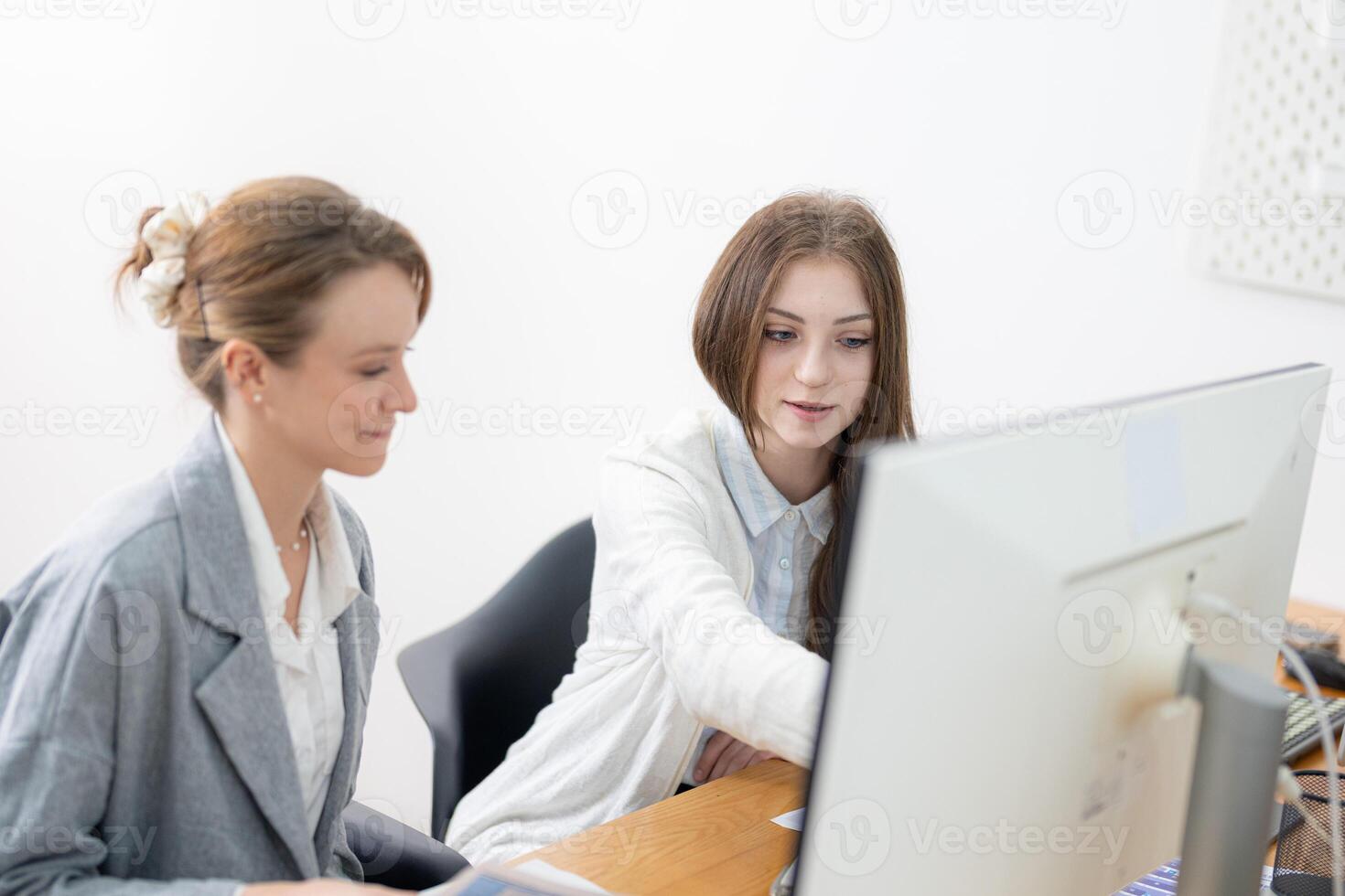 Colleagues collaborating on a project in a modern office space during a productive afternoon photo