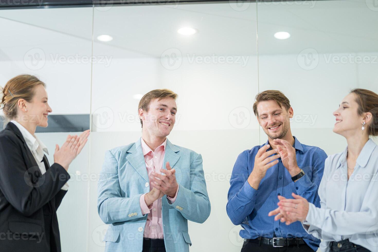 Business team celebrates success in modern office environment during a team meeting photo