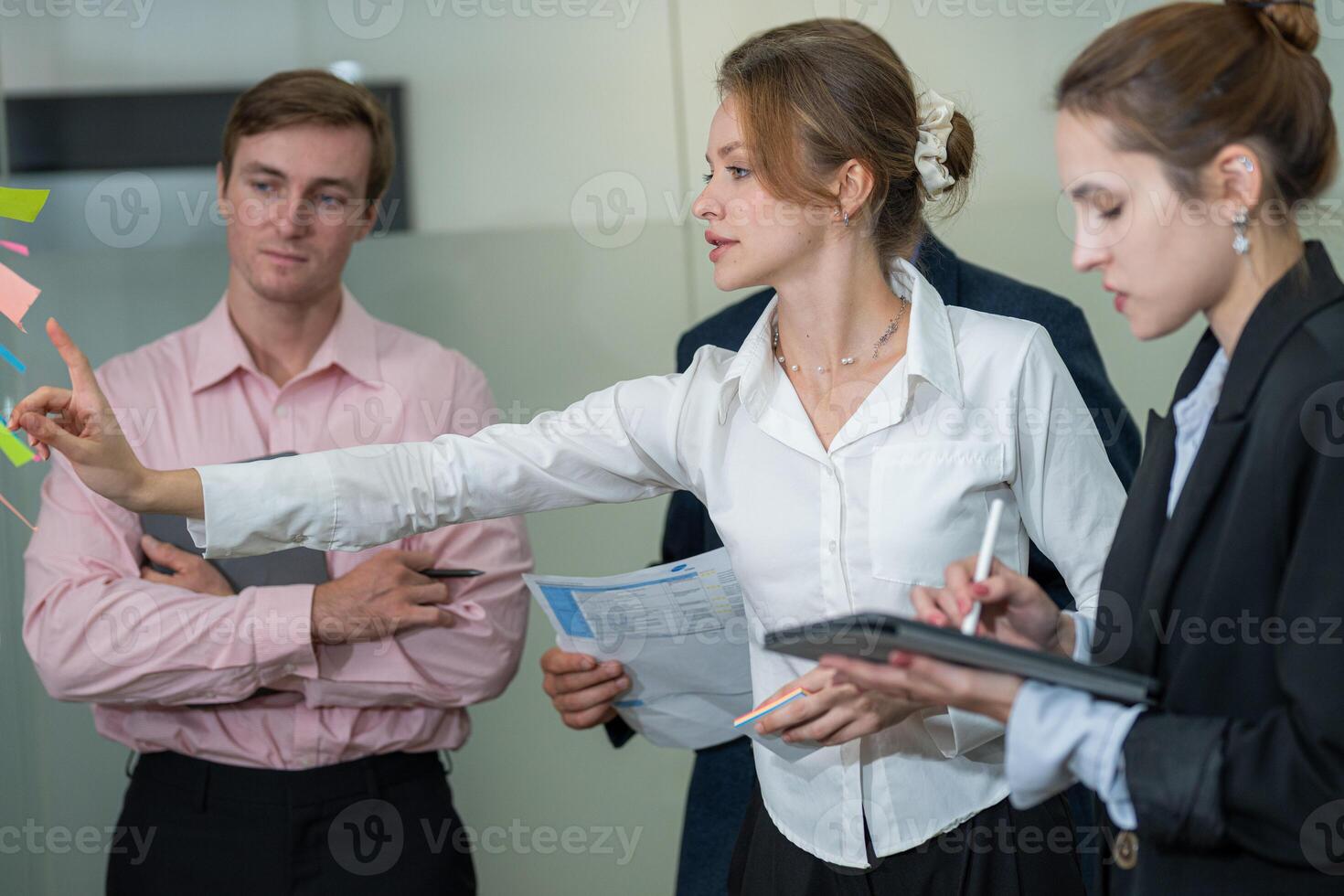 Team brainstorming session in a modern office with focus on project planning and collaboration among colleagues photo