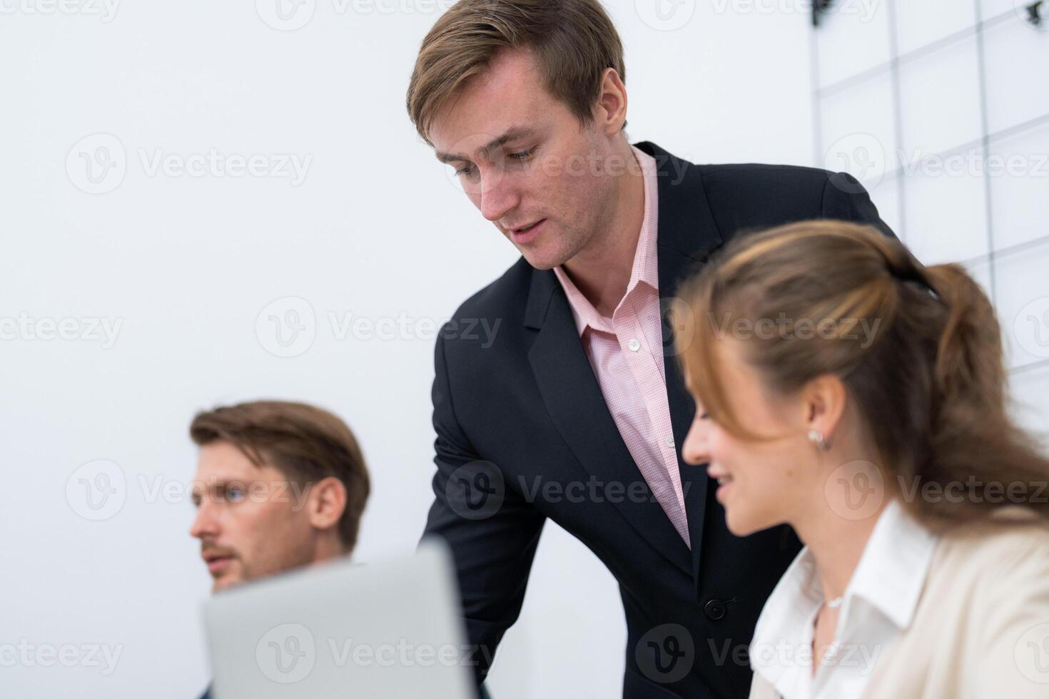 Team members collaborating in a modern office setting during a business meeting photo