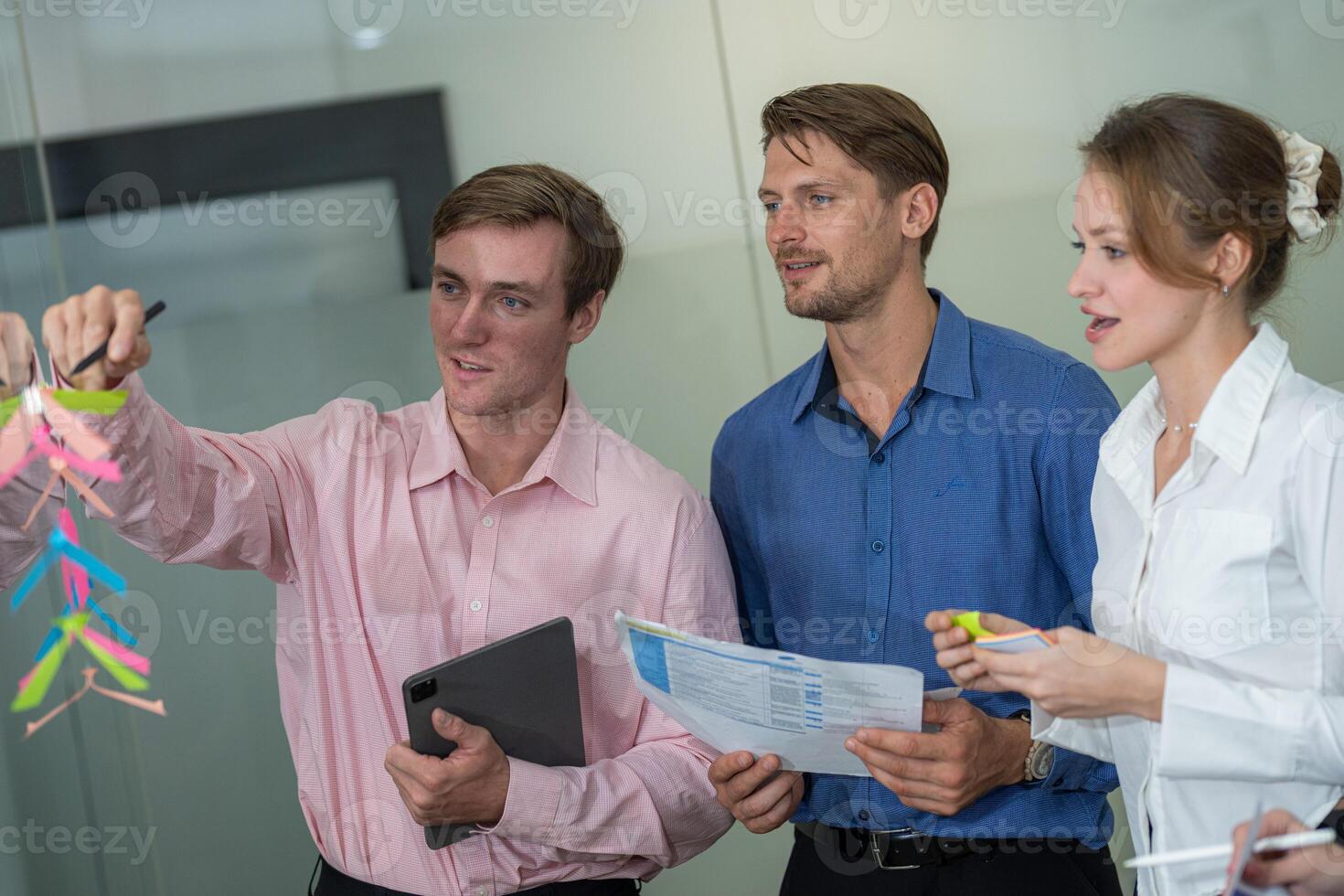 Team collaborating on innovative project presentation in modern office environment during daytime photo