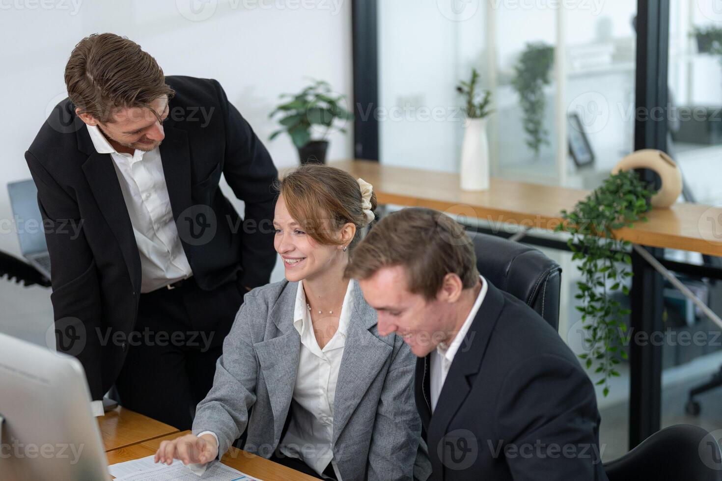 Business team collaborates to solve a project in modern office setting during daytime photo