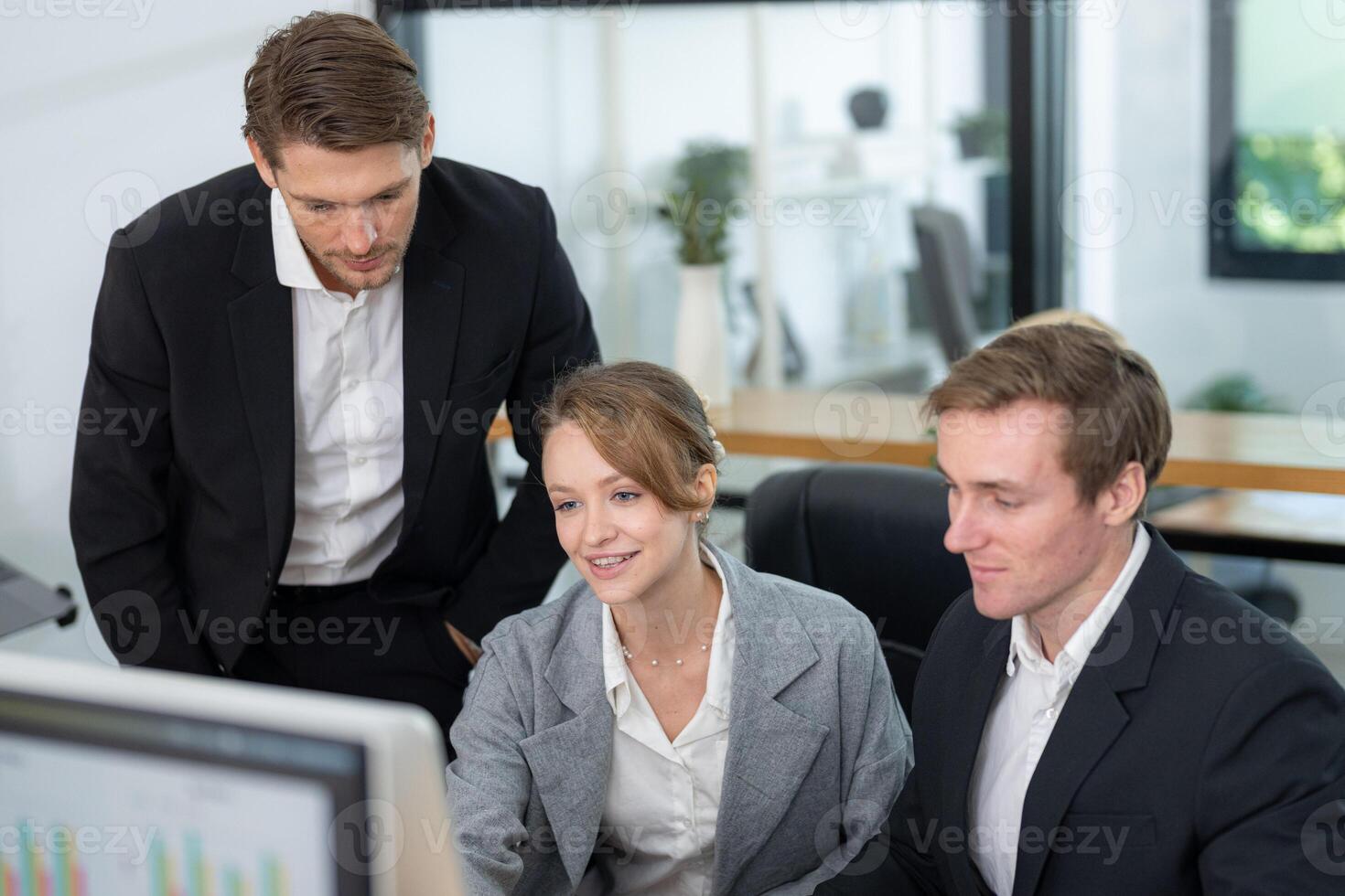 Business team collaborating on a project in a modern office setting during the day photo