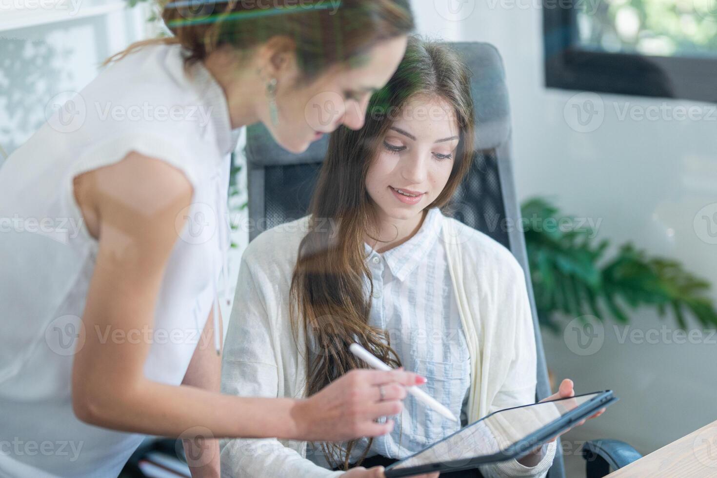 Team members collaborate on digital project in modern office environment during busy workday photo
