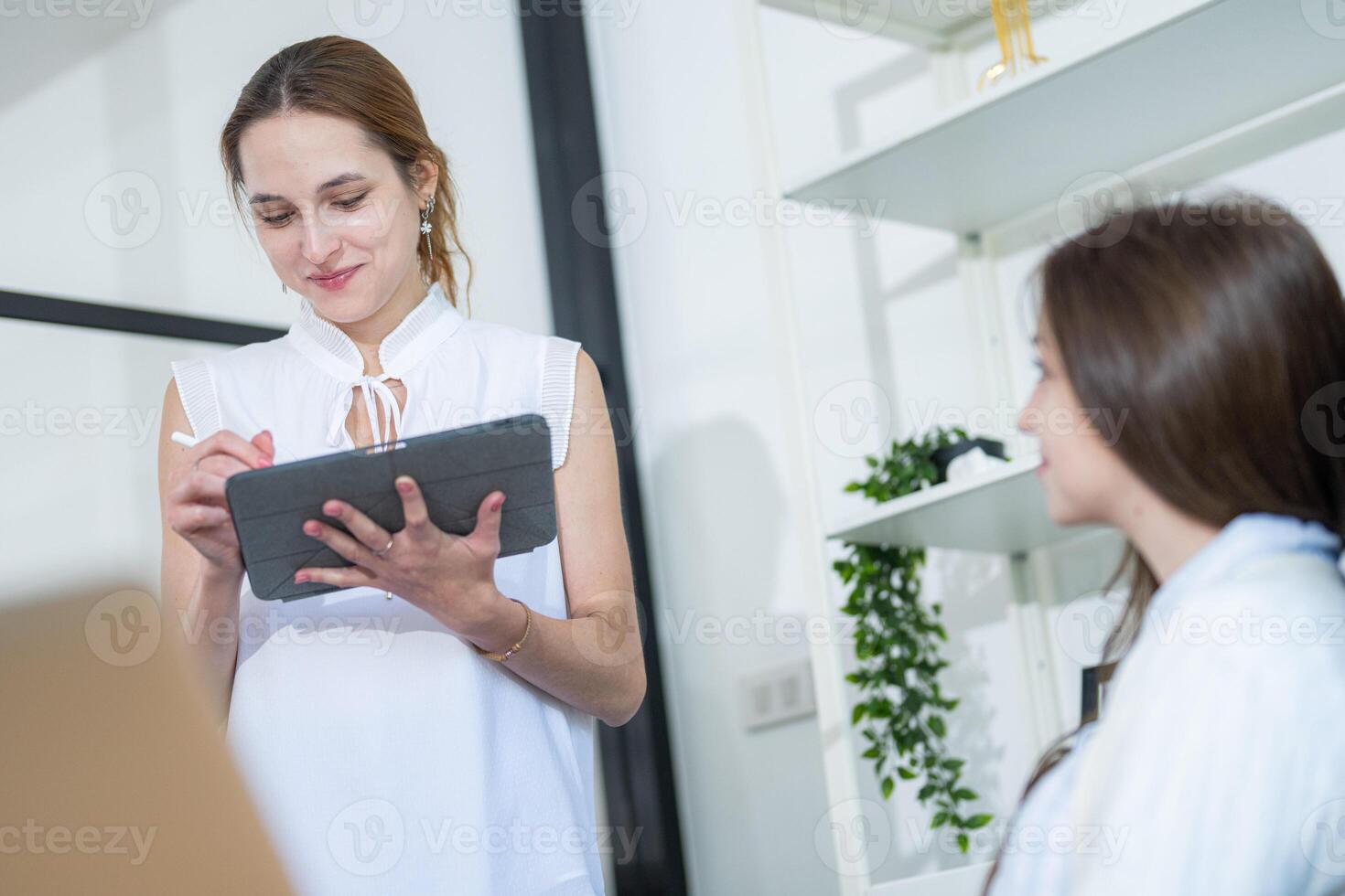 Engaging conversation between colleagues in a modern office setting during a brainstorming session photo