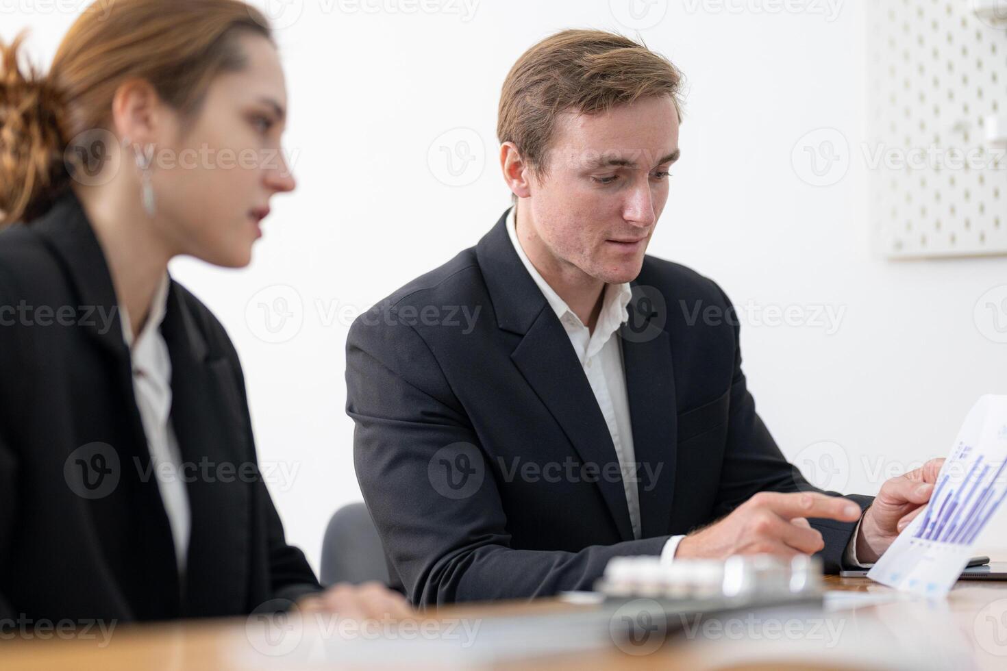 Business professionals collaborate on project in modern office during a team meeting discussing strategy photo
