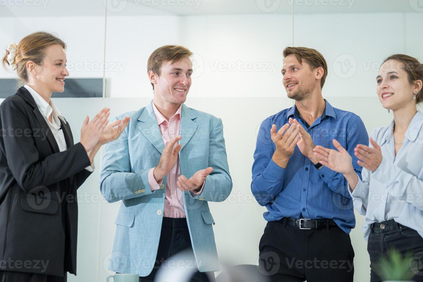 Employees celebrating success in a modern office setting during a business meeting photo