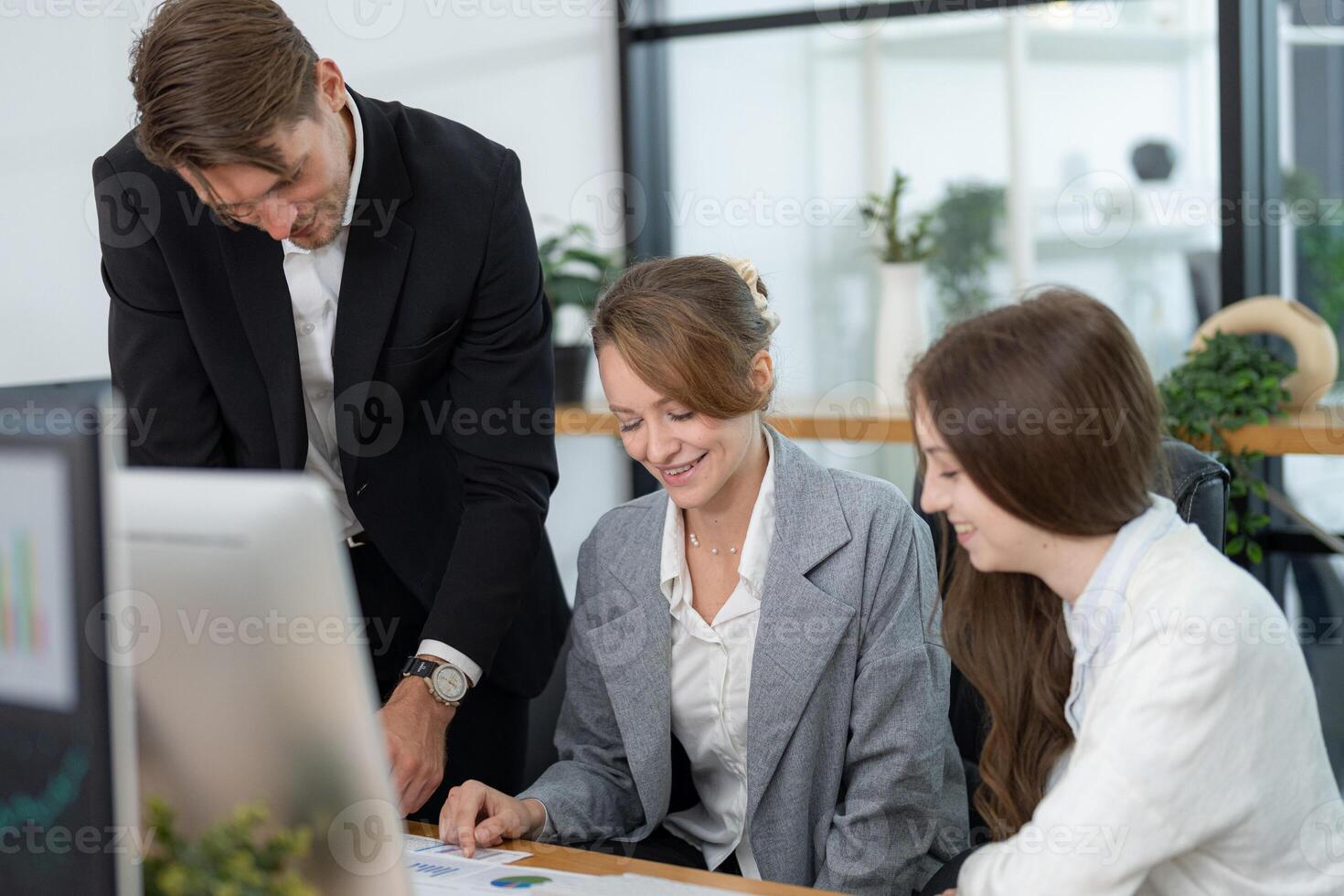 Team collaboration in an office setting with professionals discussing a project photo