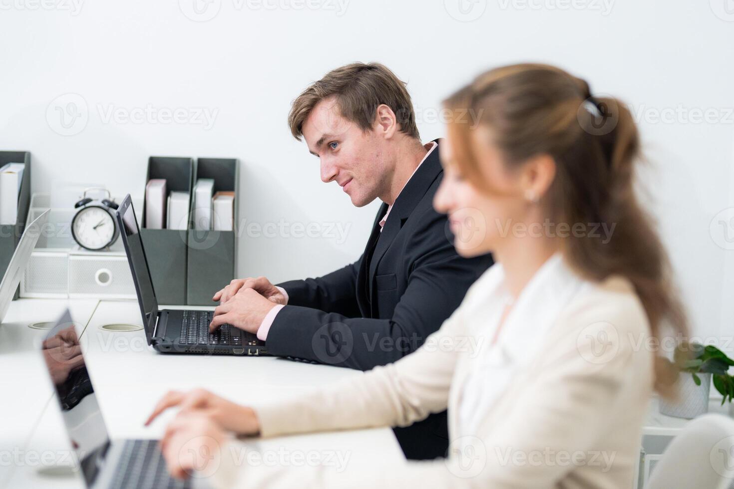 Focused professionals collaborating in a modern office space during a productive workday photo