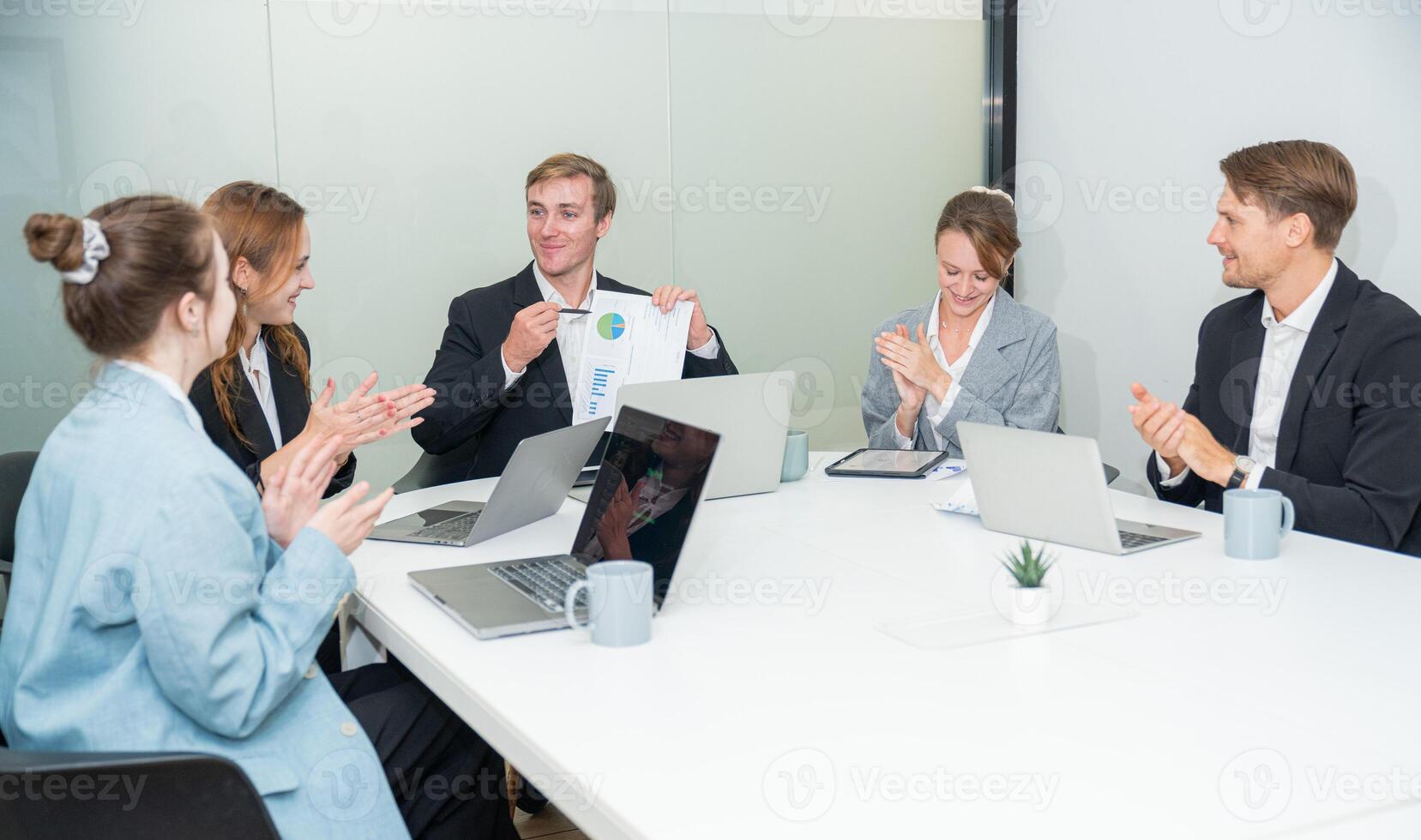 Team celebrates project success during a meeting at a modern office in the afternoon photo