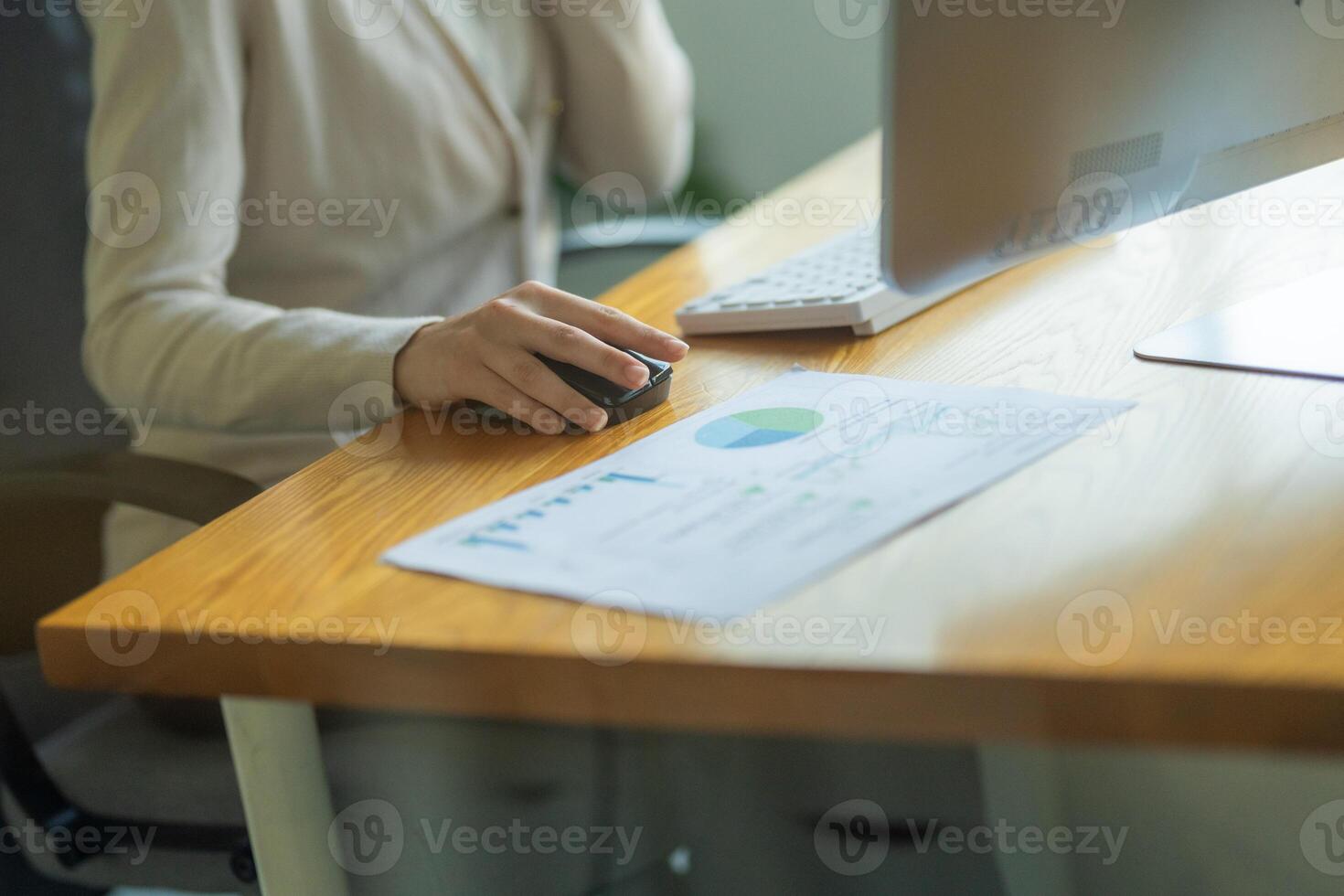 Business professional engages with financial data while working at modern office desk during daytime photo