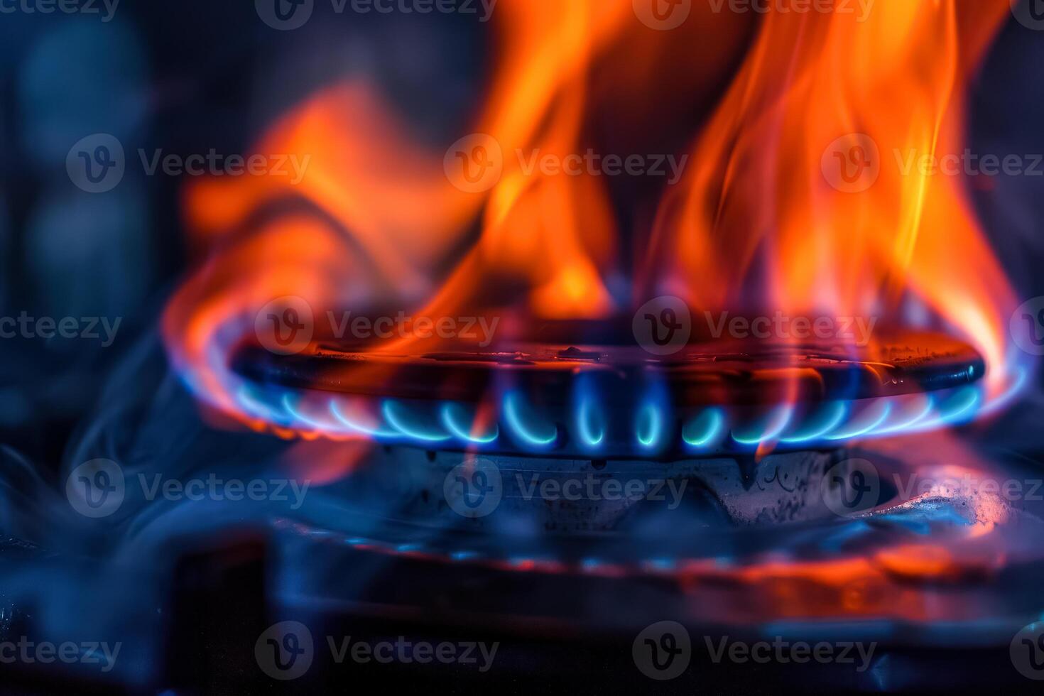 Close up of a gas stove burner with blue and red flames photo