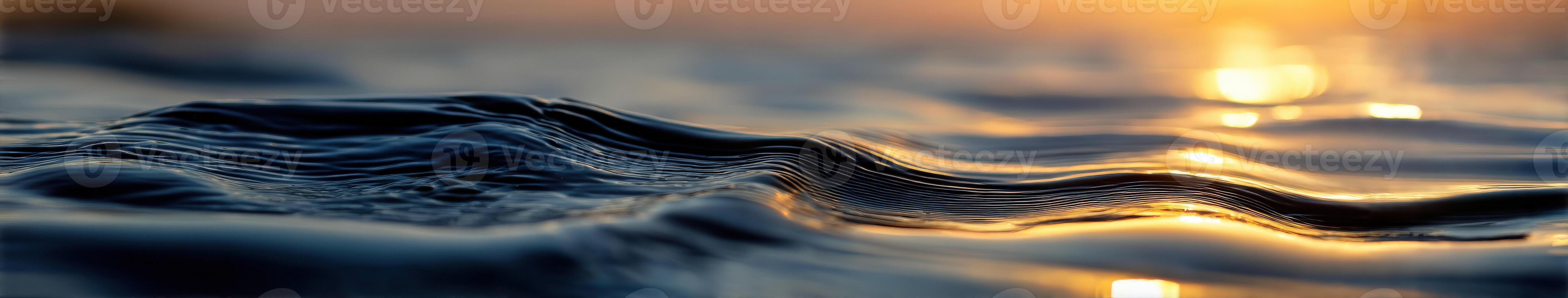 Water waves shimmer in golden sunset light photo
