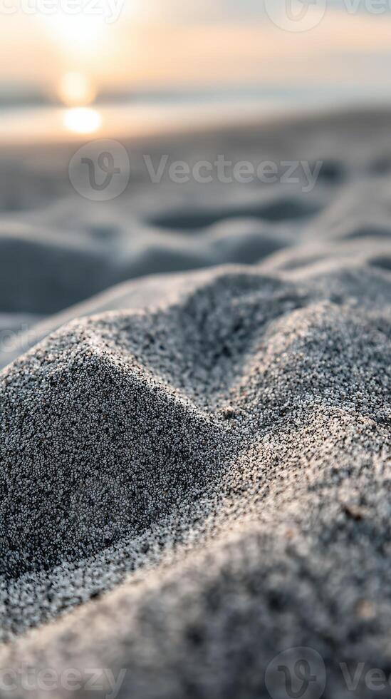 A close up of sand on the beach at sunset photo