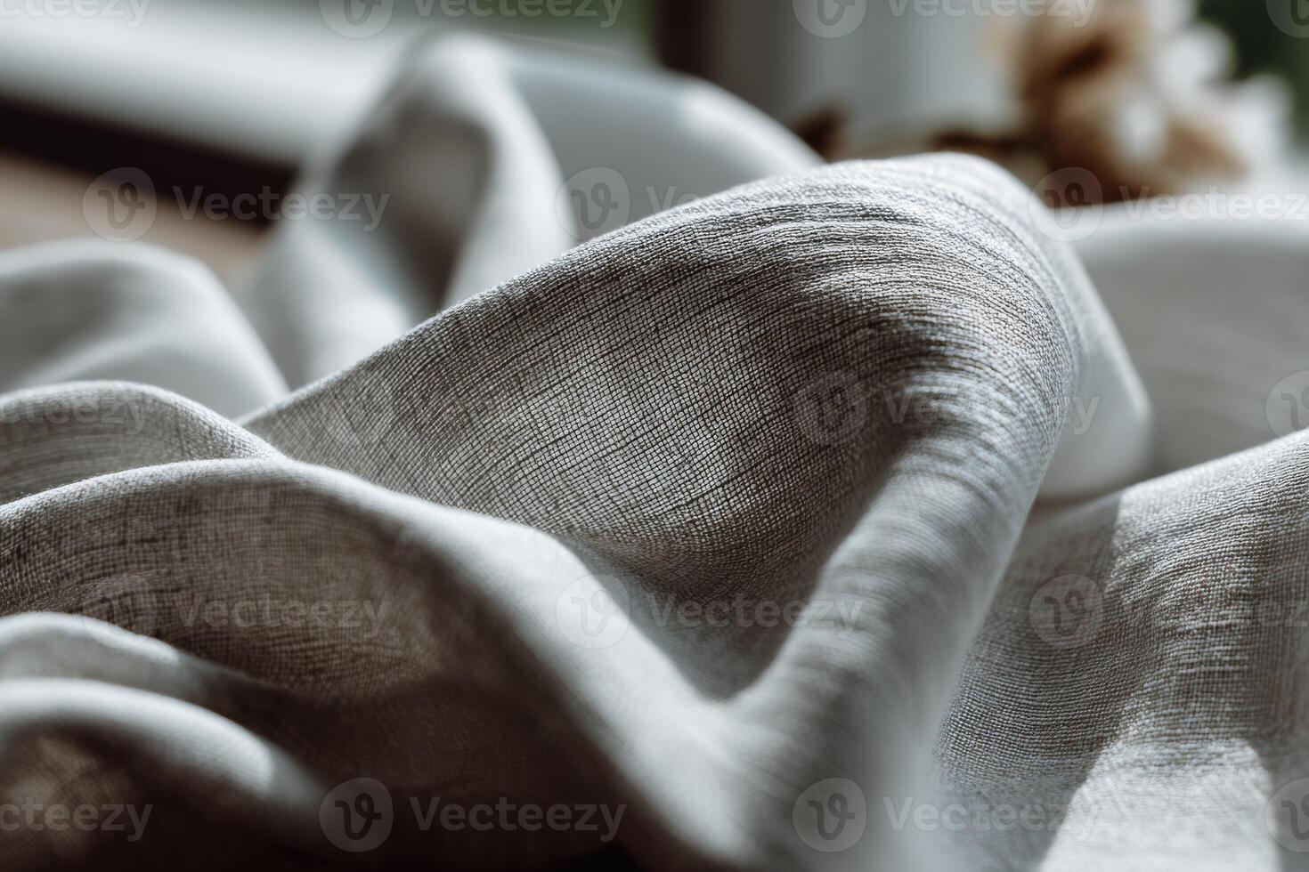 Curved linen fabric draping softly against a natural light backdrop photo