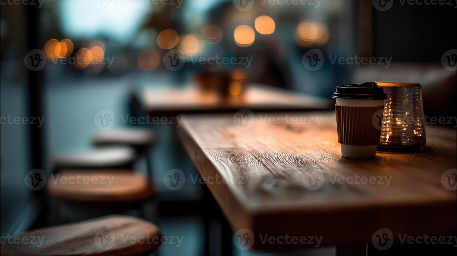 Coffee cups on wooden table with lights in background photo