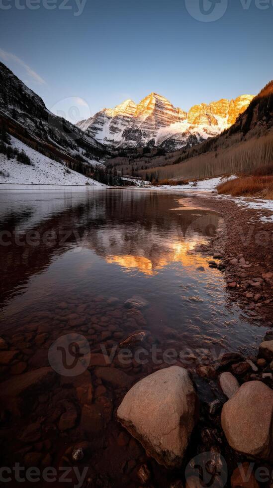 Sunset reflections over a serene mountain lake photo