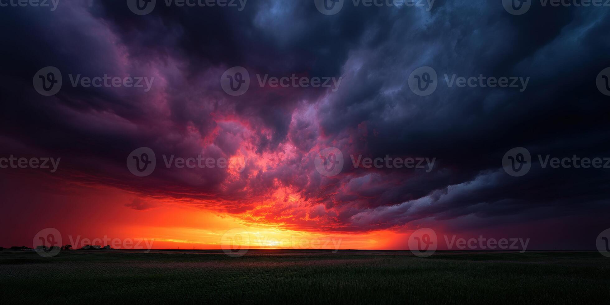 Dramatic sunset over a vast landscape with dark clouds photo