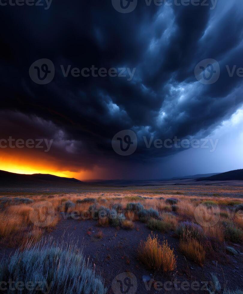 Dramatic storm clouds over a vast field at dusk photo