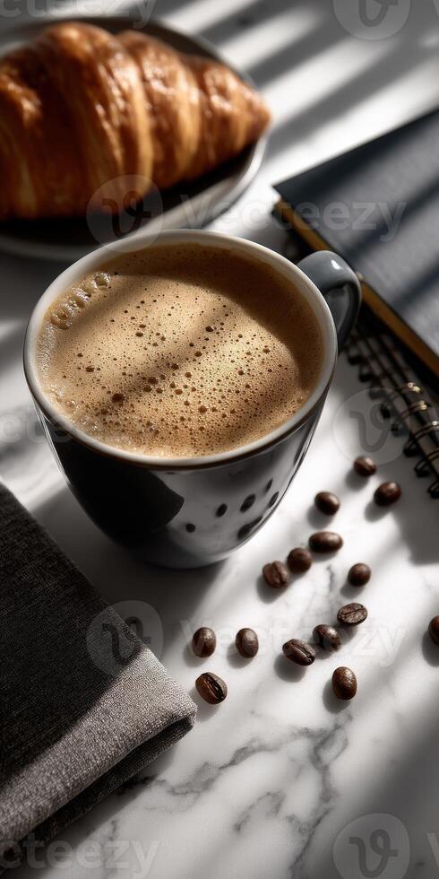 Coffee and croissant on a white marble table with a notebook and a cup of coffee photo