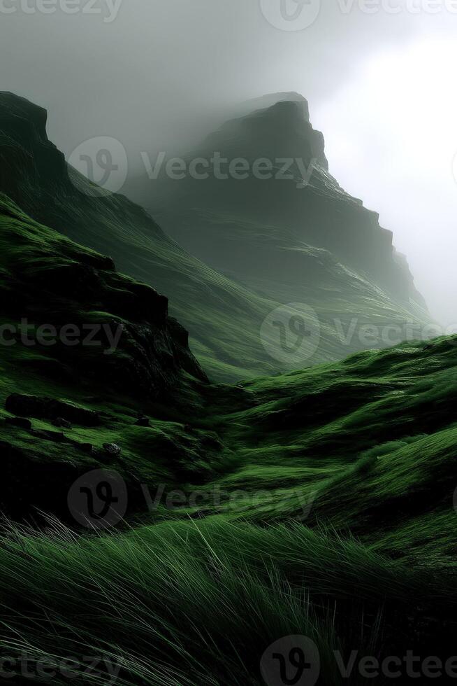 A green grassy hillside with mountains in the background photo