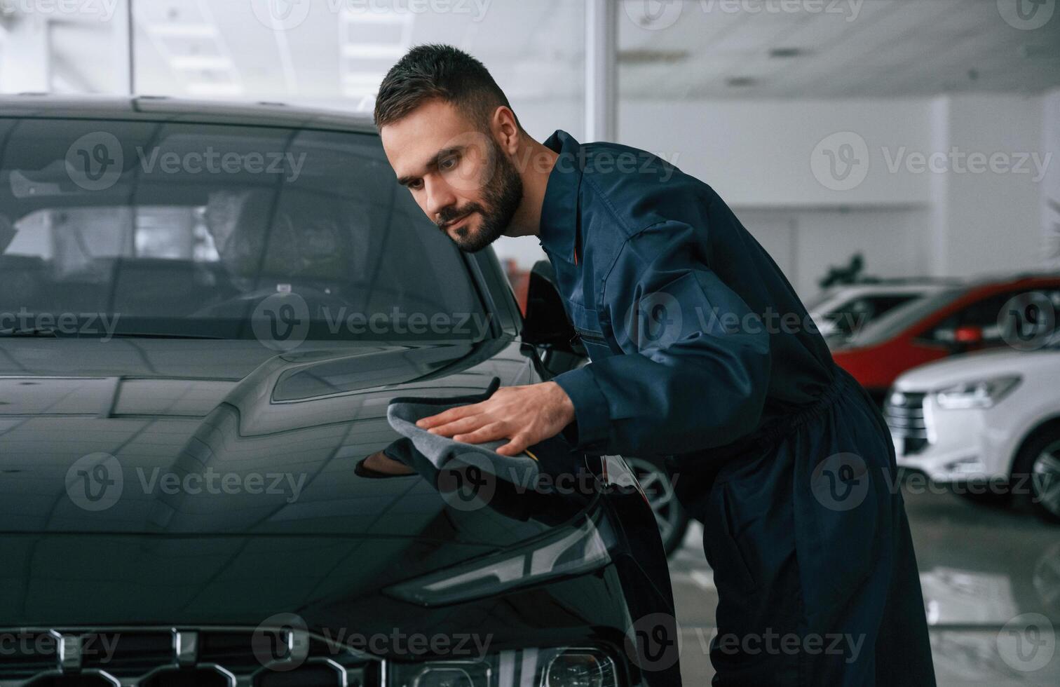 Polishing, the vehicle. Car ,repairman is in the garage with automobile photo