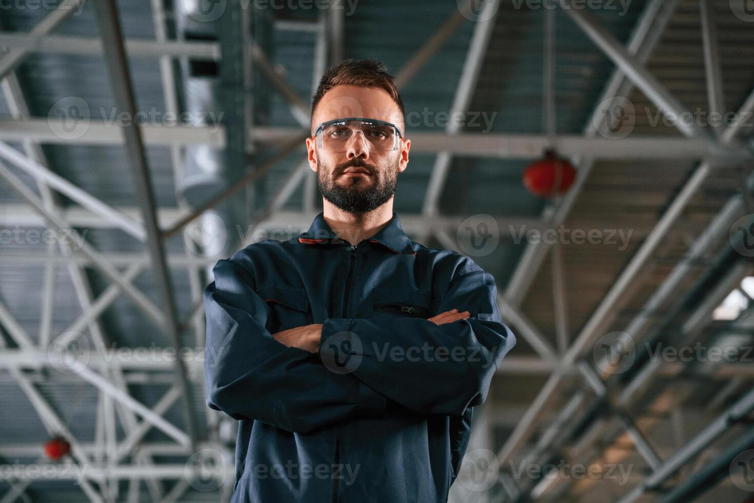 Standing, and posing. Car, repairman is in the garage with automobile photo