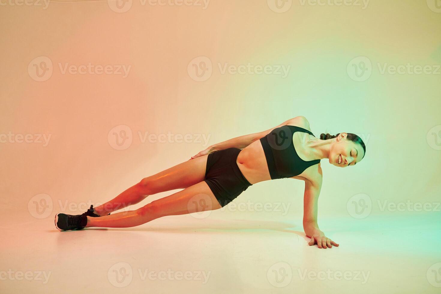 Conception, of fitness. ..Young woman ,in sportive clothes against background in studio photo