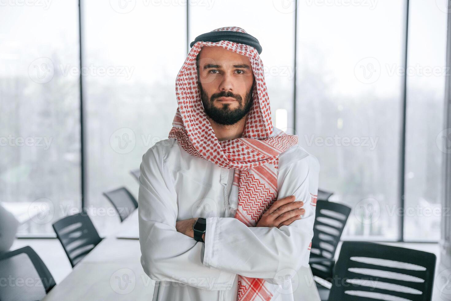 Successful Muslim businessman in ,traditional outfit in his office photo