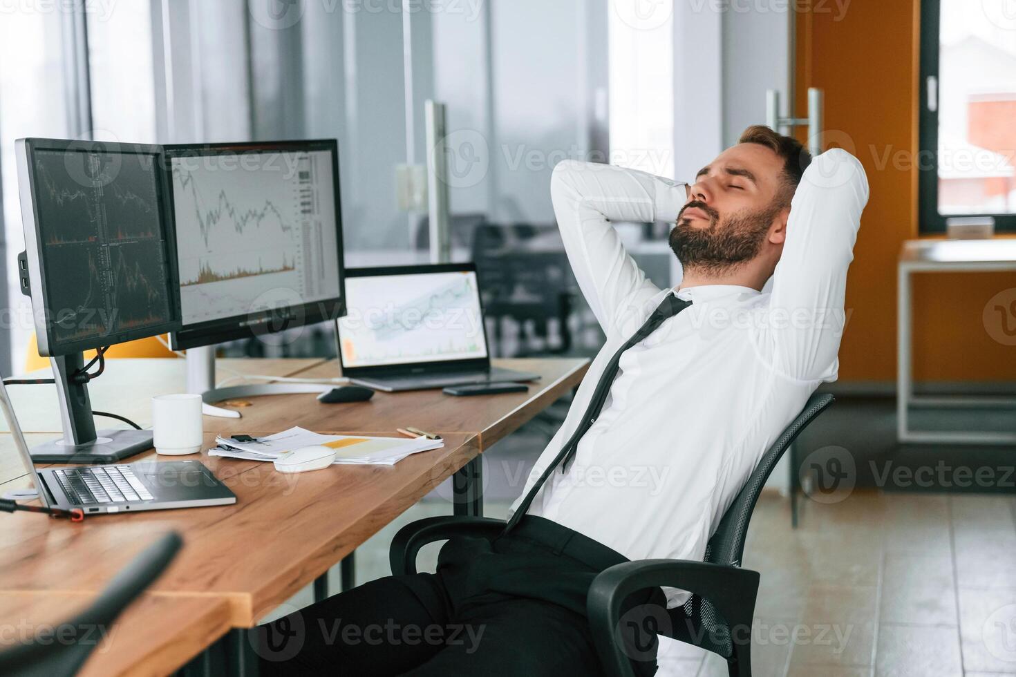 Taking ,a ,break, resting.. Businessman is sitting by computer and working in the office photo