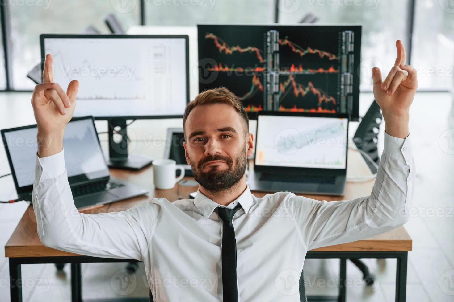 Businessman,, is sitting by computer and working in the office photo