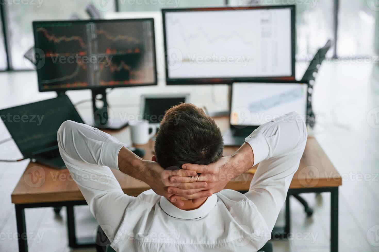 Rear ,view. Businessman ,is sitting by computer and working in the office photo
