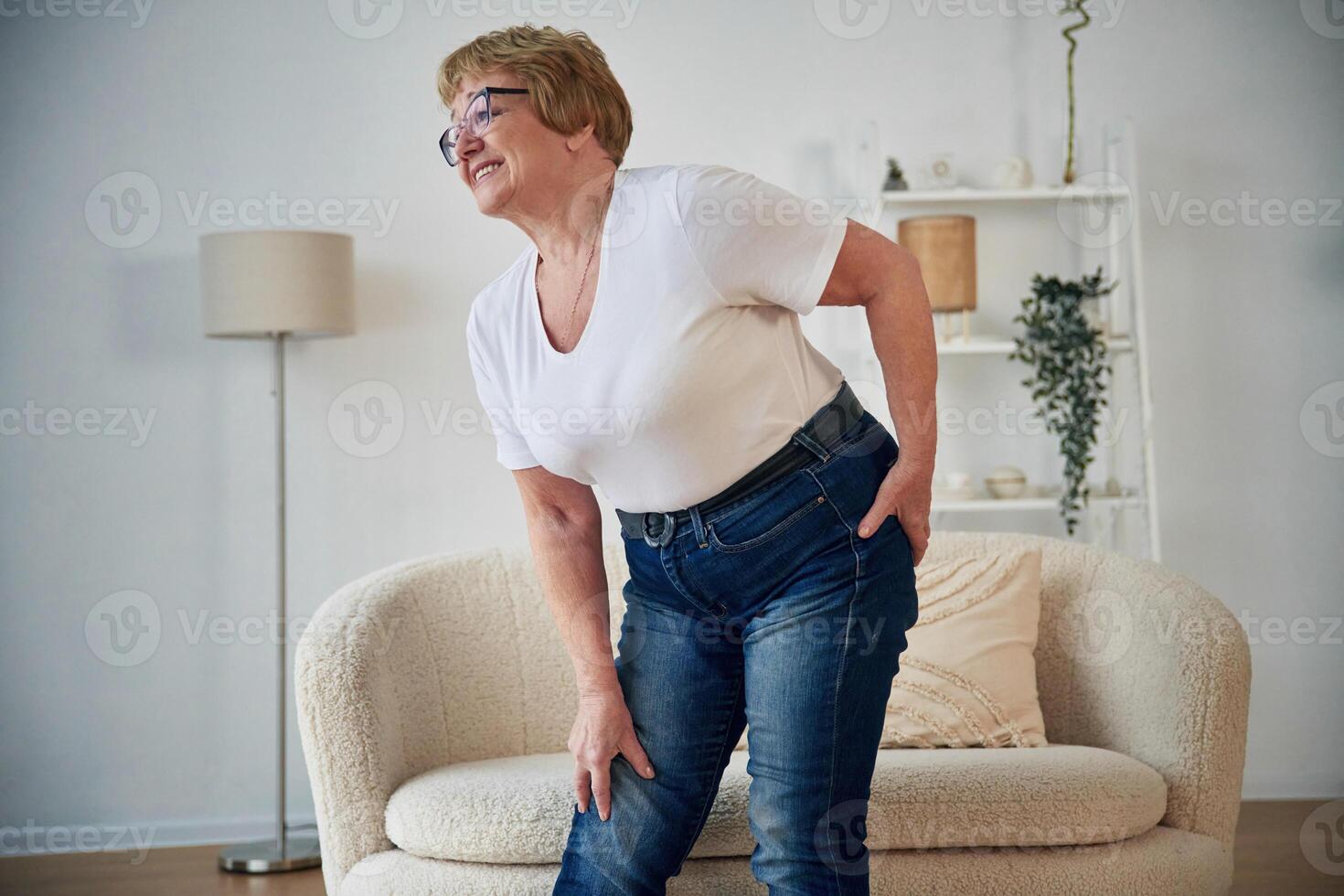 Pain, in, the leg. Senior elderly woman, is at home in the living room photo